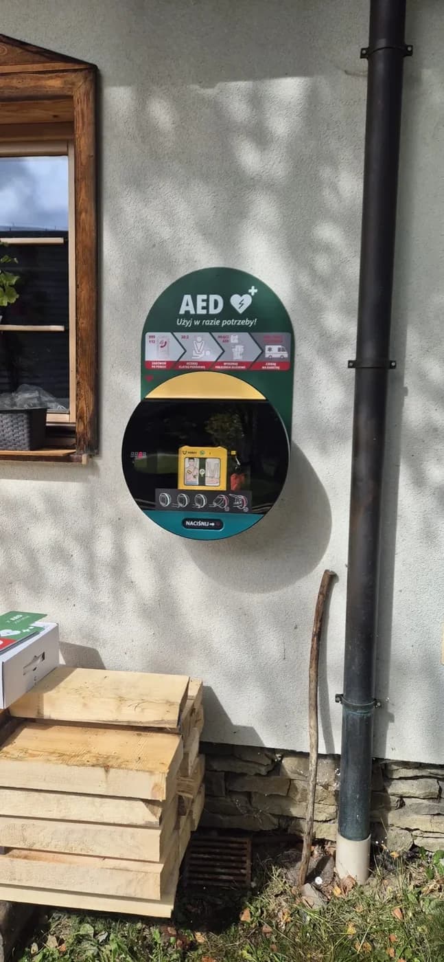 Szafka AED na ścianie budynku Orawskiego Parku Etnograficznego